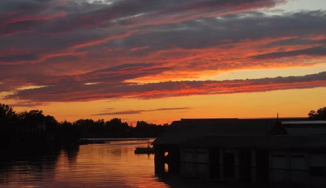 Waterfront Home with dock and a sunset view