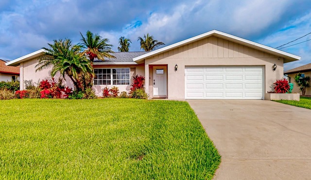 Waterfront home with an enclosed pool, outdoor kitchen, and grill - dog-friendly