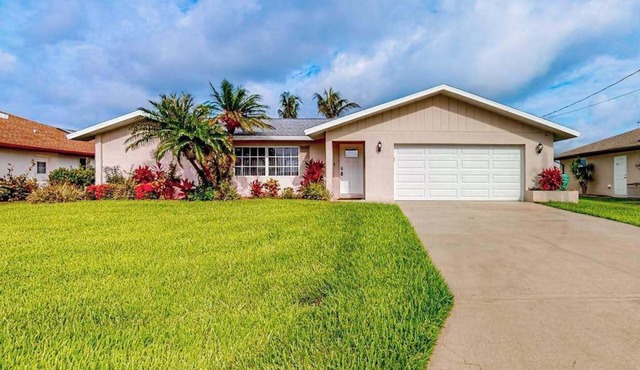 Waterfront home with an enclosed pool, outdoor kitchen, and grill - dog-friendly