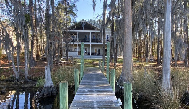 Waterfront home with dock and community boat ramp and HUGE screened in porch.