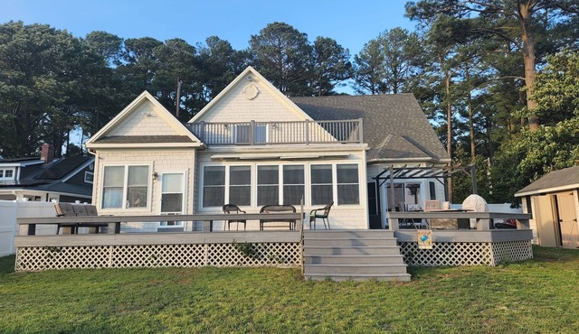 Waterfront home with dock, gazebo, and fenced yard
