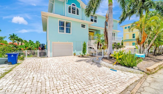 Waterfront home with private pool, dock, patio, balconies, & bikes