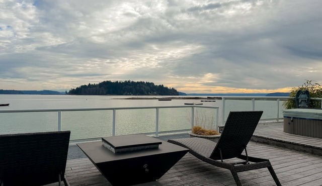 Waterfront home with private hot tub, game room with game tables, and water toys