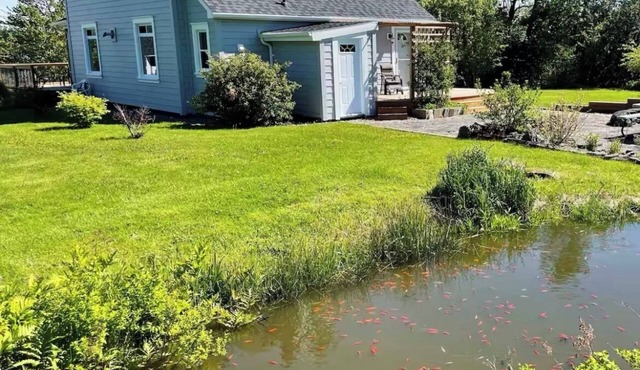 Waterfront homestead on 4 landscaped acres.