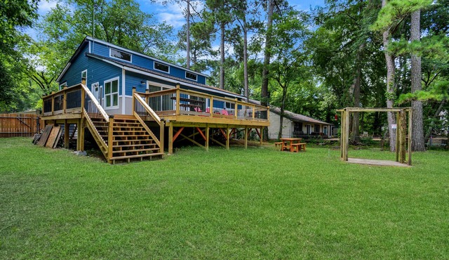 Waterfront house with a large deck and dock for boat or fishing