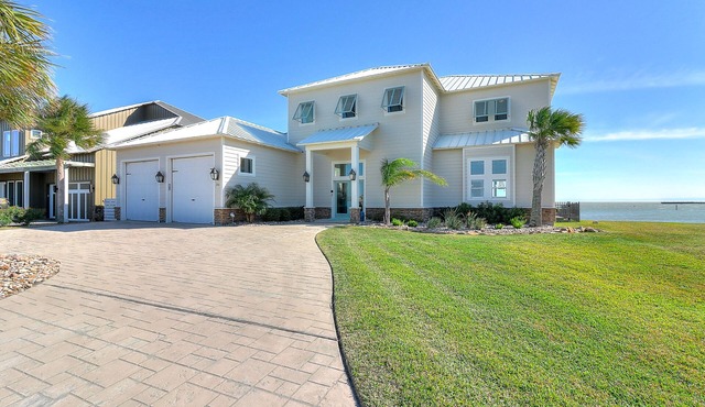 Waterfront infinity pool paradise with stunning sunset views at The Reserve