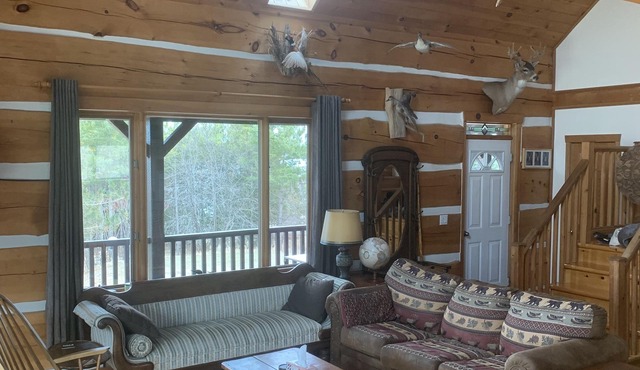 Waterfront log home on Lake Dore. Decks, dock, outdoor hot tub and fire pit.