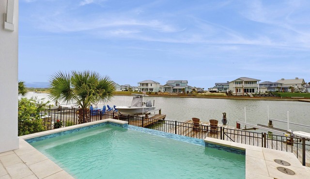 Waterfront luxury with private dock, outdoor kitchen, infinity pool & pier