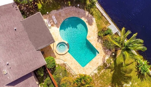 Waterfront Paradise with Tropical Palms, Swimming Pool & Hot Tub + Huge Backyard