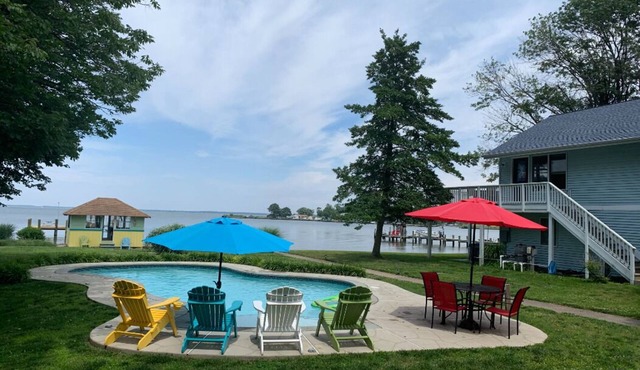 Waterfront property on 3/4 acres with private beach, pool, hot tub, and pier.