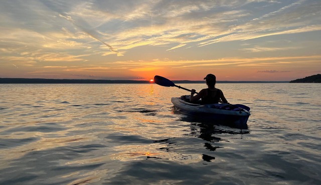 Waterfront retreat on 7 private wooded acres with beautiful sunset views.