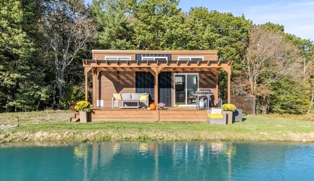 Waterfront Tiny House Perched on the Pond Covered Deck at Water’s Edge
