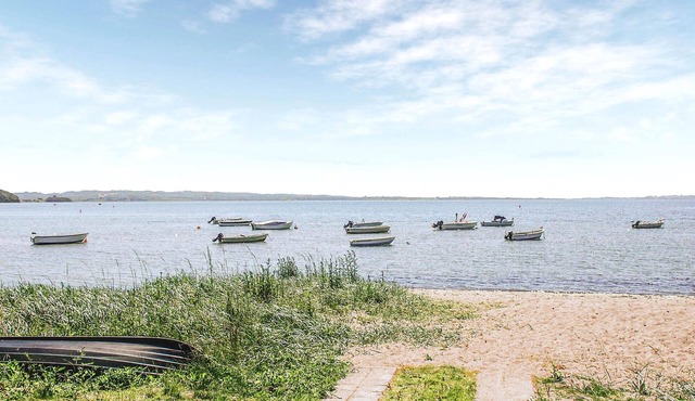Welcome to this quiet cottage surrounded by trees near Mols Bjerge National Park.