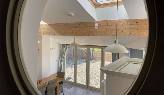 Well Cottage is a refurbed flint cottage with views across the marshes