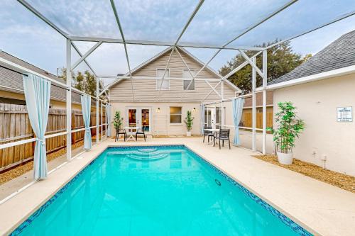 Whimsical sunlit retreat with private pool, patio, & game room - close to parks