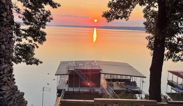 Wonderful wood lodge with 200’ lakefront. Dock Well appointed and stocked.