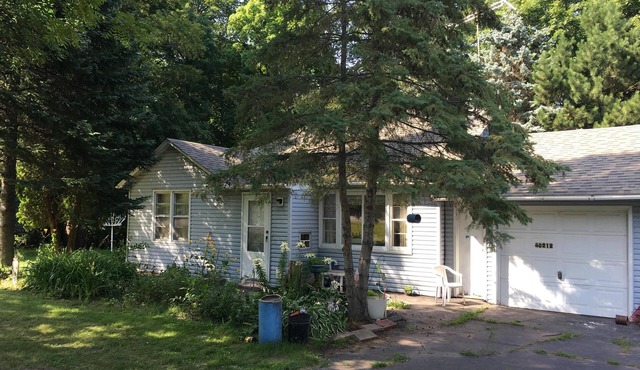 Wooded back yard with porch Randys rentals