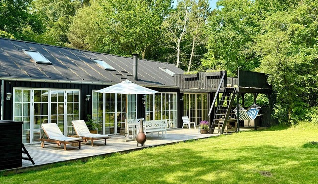 Wooden house with animals and kayaks near Aalborg
