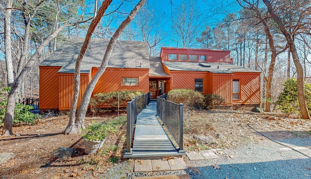 Woodland acreage with 60' deck on gurgling brook, pizza oven, rec area & library