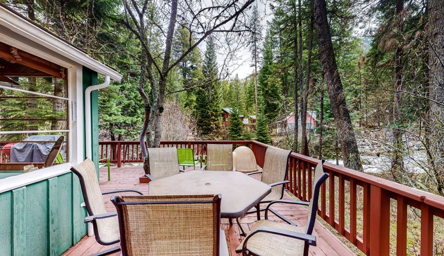 Woodsy riverfront basecamp with fireplace, large deck & firepit - dogs welcome