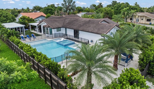 You'll be captivated by the stunning 28 x 40 custom heated pool with jacuzzi