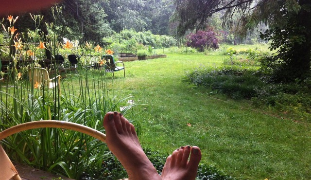 You're in a hot tub; you see gardens and hear wind blowing through the pines.