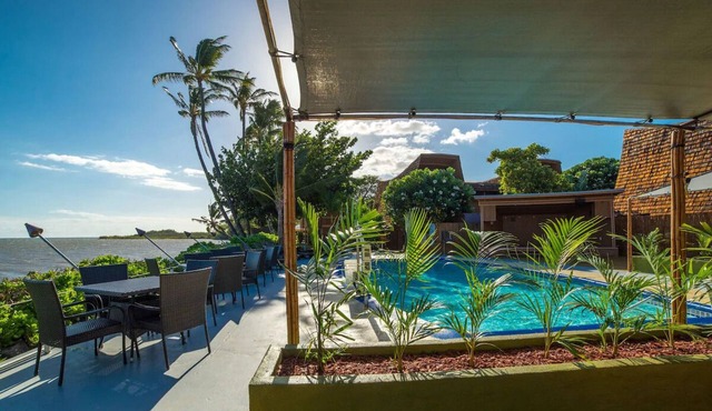 Your Ultimate Oceanfront Retreat | Relaxing Room with Lush Garden View