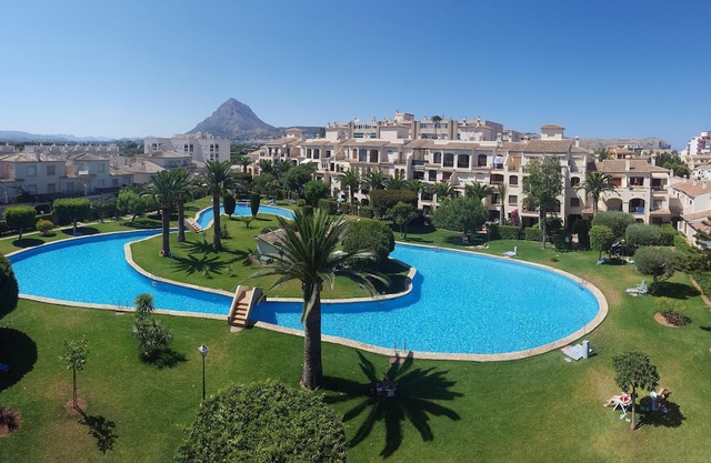 1 bedroom apartment with balcony overlooking superb communal pool and gardens