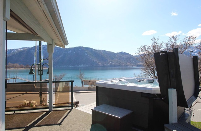 Lakeview home with wrap-around deck, easy lake access, private hot tub, & more