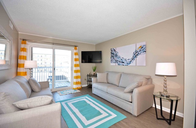 Modern, stylish 2-bedroom luxury condo with free WiFi and an outdoor pool located midtown and only one block from the beach!