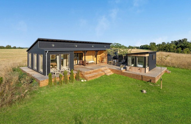 Modern, stylish cottage with bio fireplace, natural plot and views of fields.