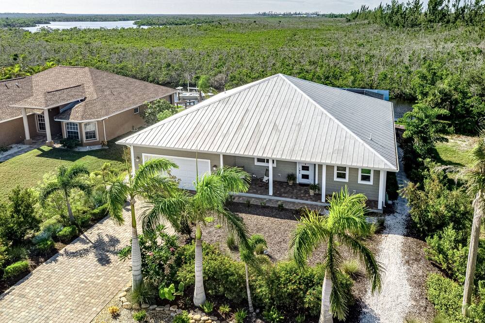 Pine Island Center House | Canal-side charmer with enclosed pool, waterside deck, open layout, & W/D