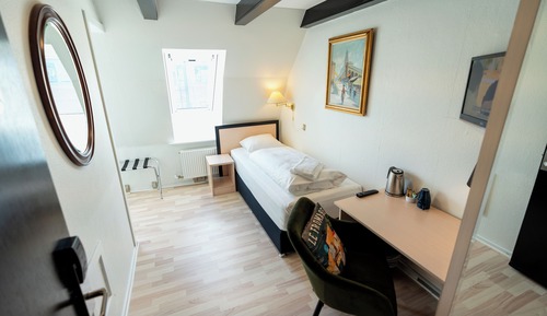 Standard single room, small bathroom, note stairs to floor