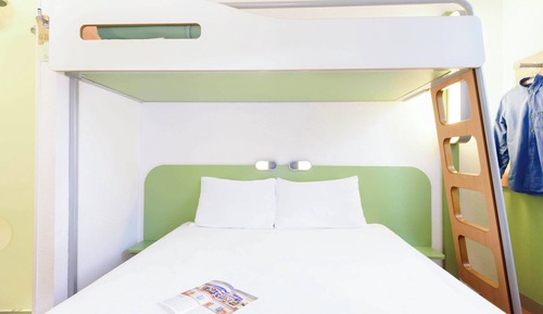Room with a large bed and a bunk bed