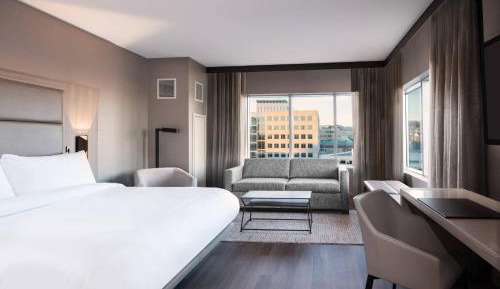 Corner King Guest Room with Sofa Bed and City View