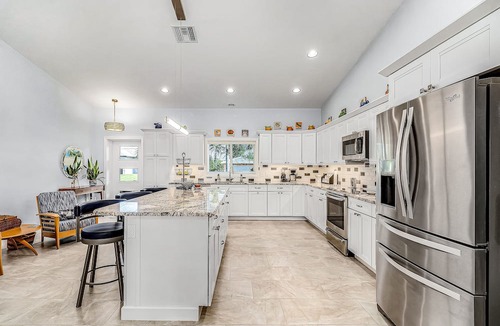 Pine Island Center House | Canal-side charmer with enclosed pool, waterside deck, open layout, & W/D