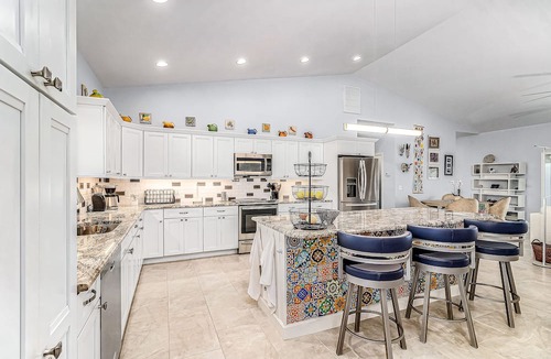 Pine Island Center House | Canal-side charmer with enclosed pool, waterside deck, open layout, & W/D