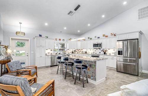 Pine Island Center House | Canal-side charmer with enclosed pool, waterside deck, open layout, & W/D