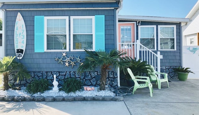 One minute drive to beach with golfcart! Newly updated, beach decor and clean!