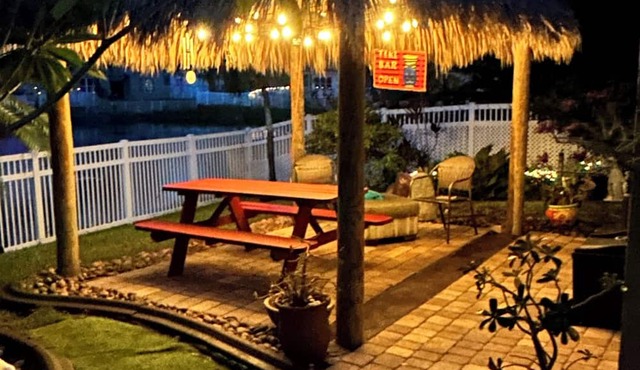 Beautiful lakefront retreat with outdoor kitchen, tiki hut and spa.