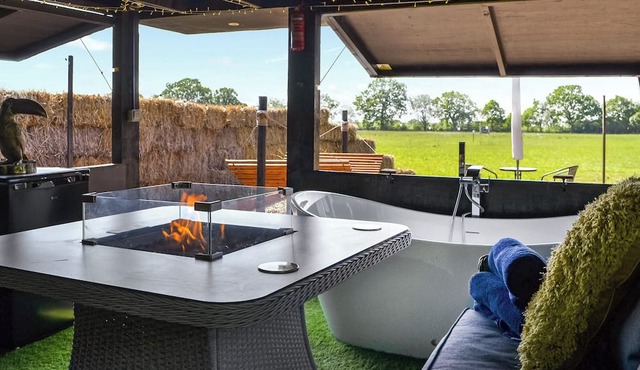 We just love the outside entertainment area with a bath for two, table top fire pit and large Smart