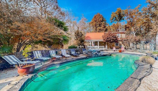 Unique and retro stay on the river with grill, hot tub, pool, & W/D access