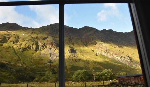 Traditional Welsh stone cottage nestled within the iconic Llanberis Pass.