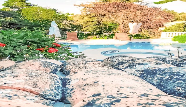 Decorative and cozy vacation apartment with communal pool and idyllic garden.